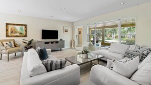 A modern living room with a sofa, armchairs, a coffee table, and a television. - BY THE SEA VACATION VILLAS 3 BED POOL/ BEACH AT END OF STREET (Lauderdale-by-the-Sea)
