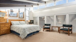 A bedroom with a large bed, two chairs, a dresser, and a TV. - SE068 | Amazing views | Hot Tub | Winter Shuttle | Ski In/Out (Steamboat Springs)
