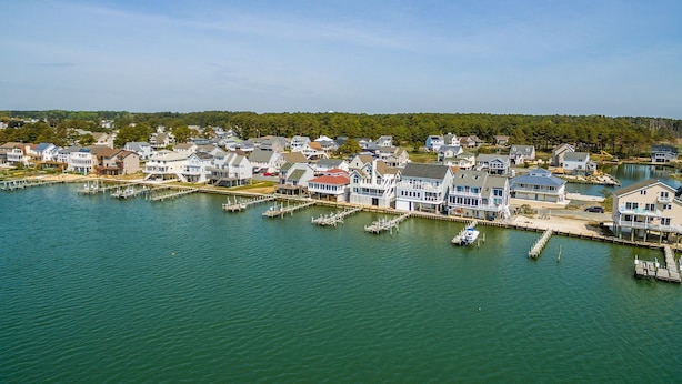 A coastal residential area with houses along a marina. - Calypso by Seaside Vacations & Sales (Greenbackville)