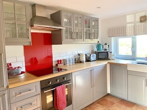 Newly installed kitchen with all appliances and essentials.