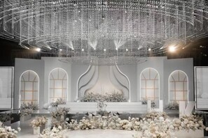 An indoor venue with a stage, arched windows, and a decorative ceiling. - Taixuhu Holiday Hotel (Hangzhou)