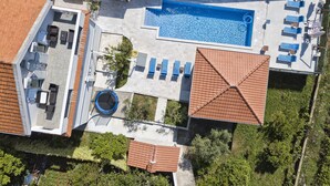 An aerial view of a residential property with a swimming pool, outdoor seating, and a covered patio area. - Spacious villa with an outdoor swimming pool (Ðuraševici)