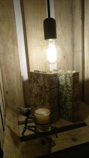 A wooden table with a candle holder and a glass candle. - CASA DAMÉLIA POLO2-House near Óbidos in the slope of recycling décor (Vau Óbidos)