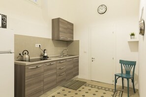A compact kitchen with a sink, kettle, and cabinets. - Stay in Rome Apartments Central Navona Sq (Roma)