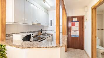 Fridge, microwave, stovetop, coffee/tea maker