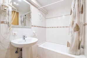 Bathtub, hair dryer, towels