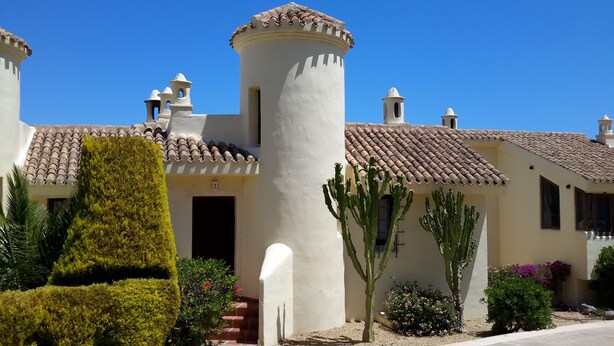 A building with a tower, a door, and a staircase. - Inviting, bright 2-Bedroom El Rancho villa in prestigious La Manga Club Resort (La Manga Club)