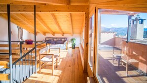 A wooden interior with a staircase leading to a balcony. - Old era of the 19th century Detached rural house Era del Mestre (Erinyà)