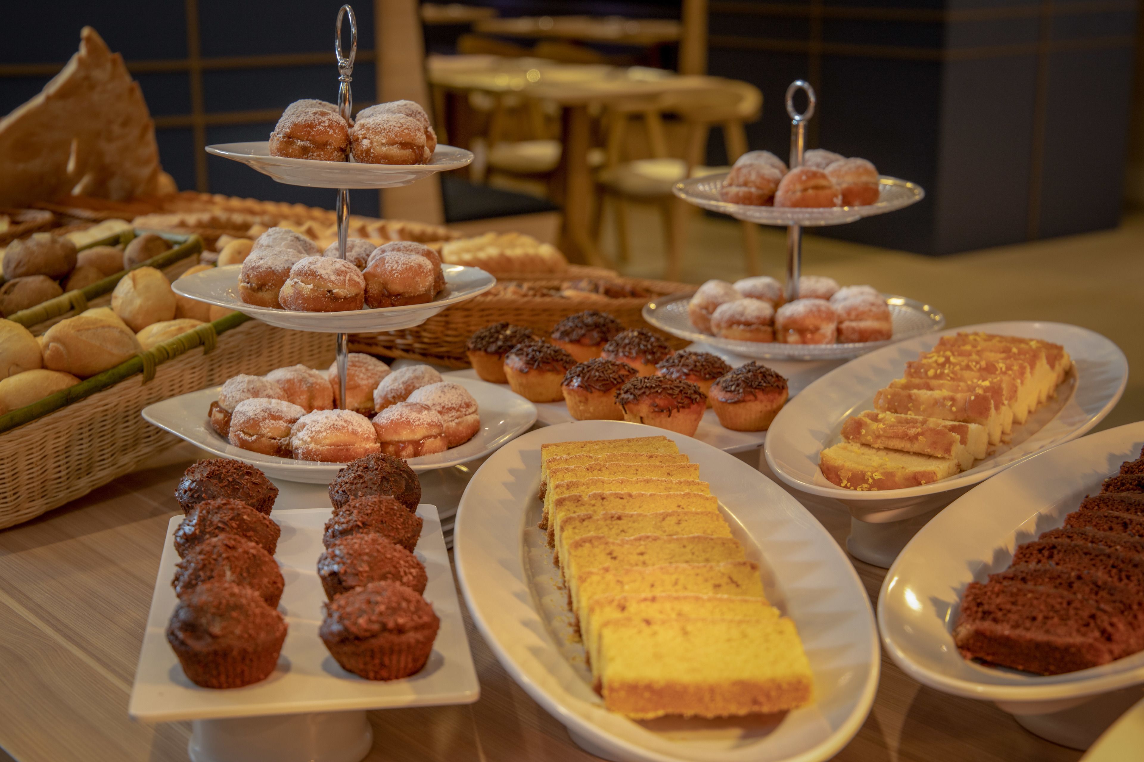 A buffet with various pastries and breads.