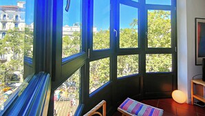 A room with large windows, a bench, and a lamp. - Gorgeous views over La Rambla. Very bright! R.A. (Barcelona)