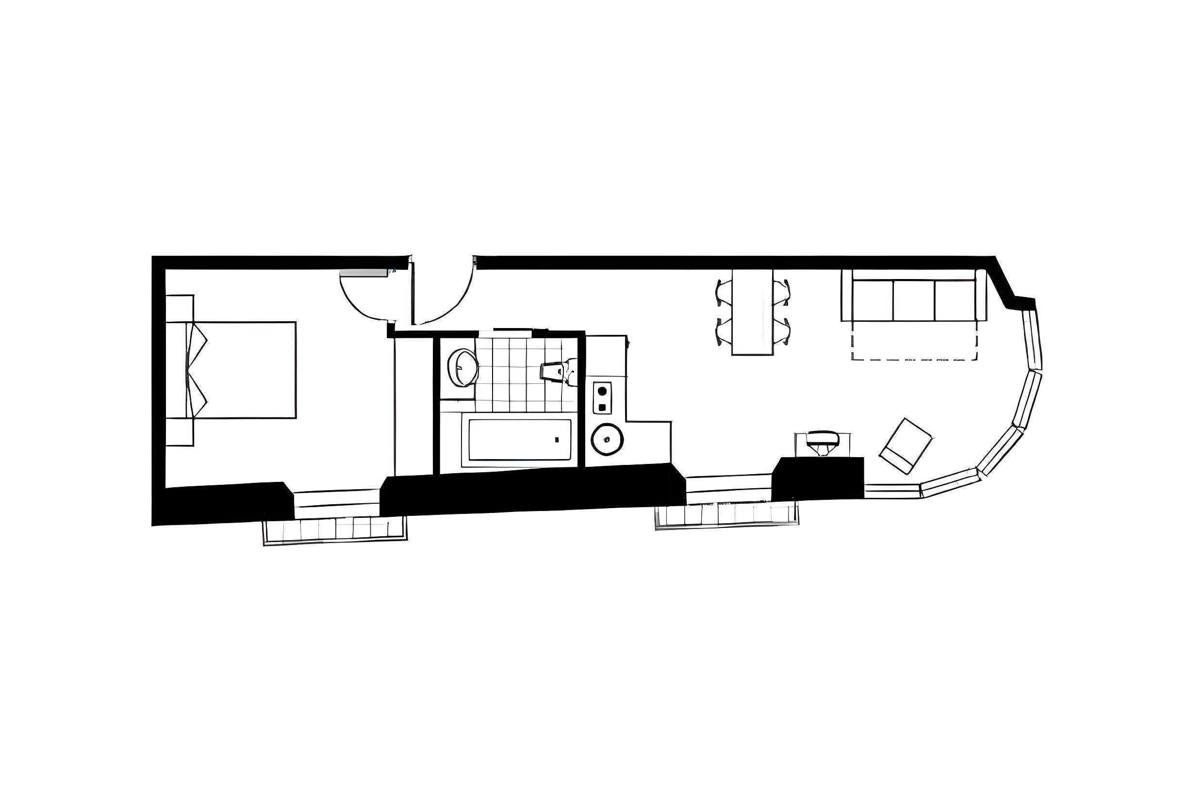 Plano de planta de una habitación de hotel con cama, baño, kitchenette y zona de estar.