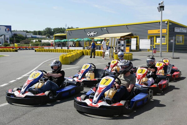 A go-kart racing track with numbered go-karts and a building labeled "GoKart" in the background.