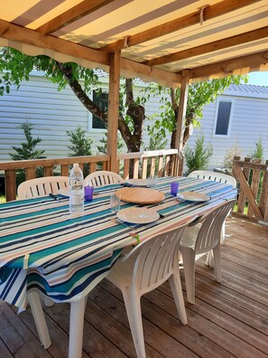 Enjoy al fresco dining on the deck with a table set for a meal.
