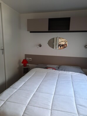 Relax in comfort with a large bed and a wall-mounted TV.