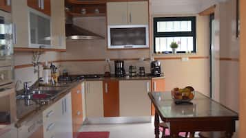 Fridge, microwave, coffee/tea maker, cookware/dishes/utensils