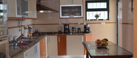 Fridge, microwave, coffee/tea maker, cookware/dishes/utensils