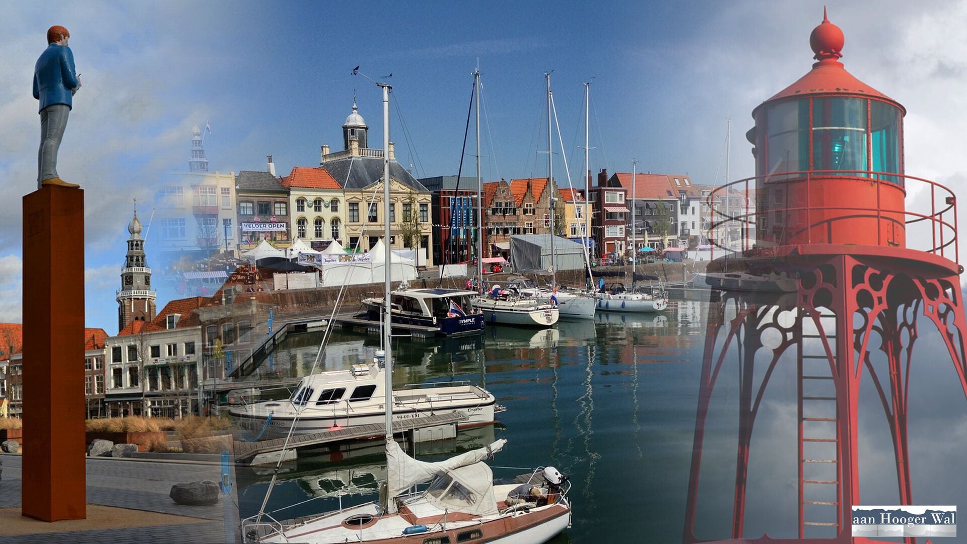 A marina with boats docked, a lighthouse, and a statue.