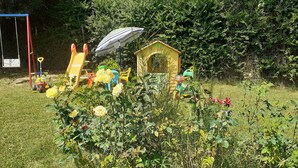 A playground with swings, slides, and a small playhouse. - House in Tuscany immersed in greenery  (Foiano della Chiana)