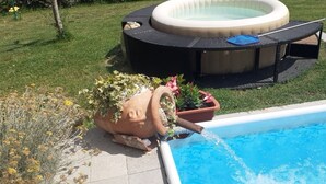 A backyard with a swimming pool, a hot tub, and a tiki bar. - House in Tuscany immersed in greenery  (Foiano della Chiana)