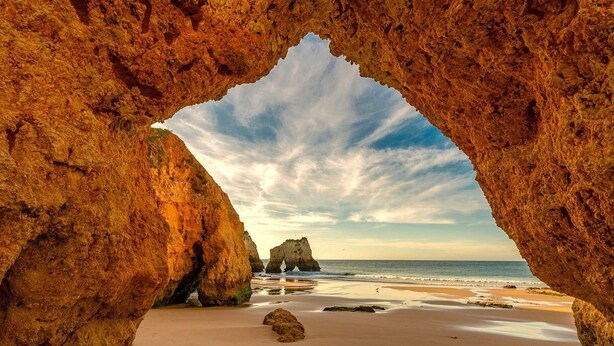 A natural rock formation with a cave-like opening framing a beach and ocean view. - 1 Bedroom Duplex with Balcony and Seaview (5-10 minutes form beach) (Alvor)