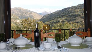 A table set for a meal with a view of a mountainous landscape. - OLIVILLAS GARDEN - BASE POINT ACCESS SIERRA NEVADA AND GRANADA (Güejar Sierra)