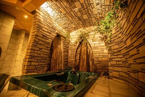 A stone-walled spa area with a hot tub and seating. - Panzl braü (Virgen)