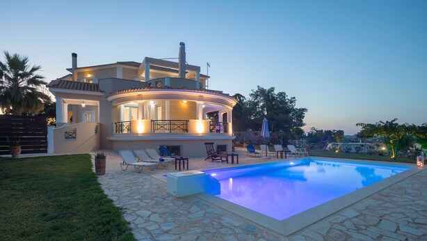 A modern house with a swimming pool, stone patio, and outdoor seating area. - Hilltop Villa with Private Pool | Panoramic Views | Sea Turtle National Park.  (Zakynthos)