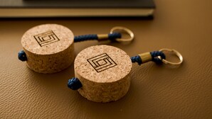 Two cork keychains with a geometric design on a textured surface. - Nightingale Apartments (Porto)