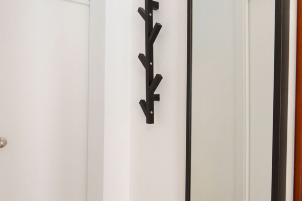 A white door with a black wall-mounted coat rack. - RentalSevilla Enladrillada Center City (Sevilla)