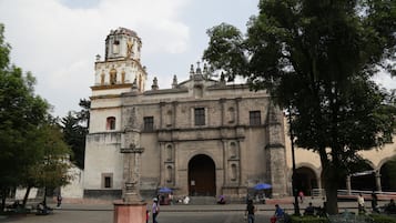 A historic building with a prominent bell tower and an arched entrance.
