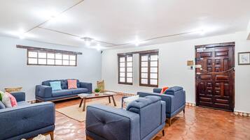 A living room with two sofas, a coffee table, and a wooden door.