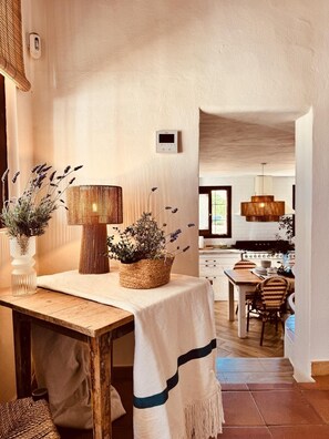 A cozy dining area with a table, chairs, and a woven basket with plants. - Nice house with pool in a quiet area. (San Francisco Javier)