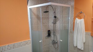 A modern bathroom with a glass-enclosed shower, a glass sink, and a white toilet. - Limena's penthouse apartment (Limenaw Hersonisou Crete)