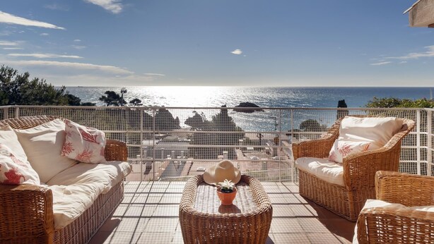 A covered outdoor seating area with wicker furniture and a view of the sea. - SAILOR HOUSE with SEA VIEWS (Tossa de Mar)