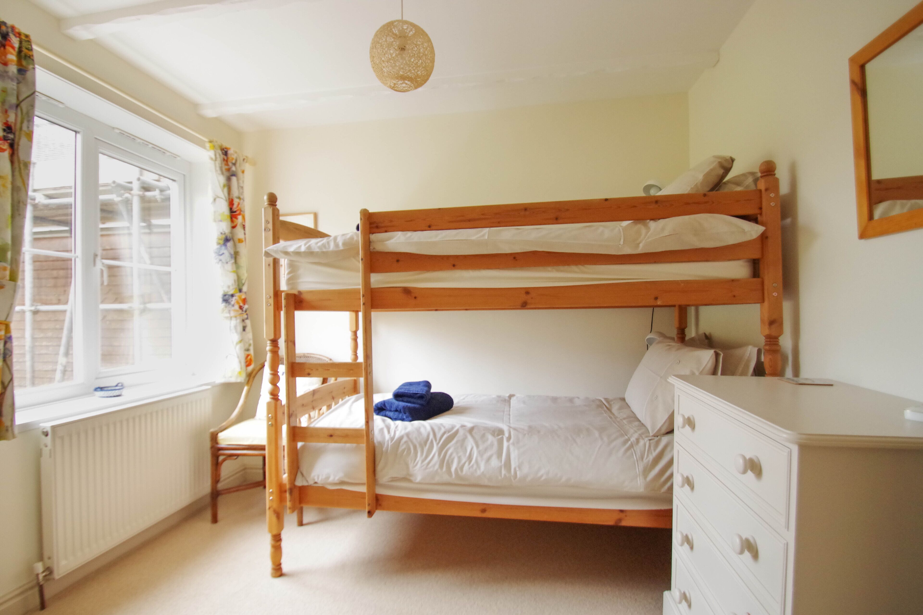 Bunk room.  Full size single beds, wardrobe, chest of drawers.
