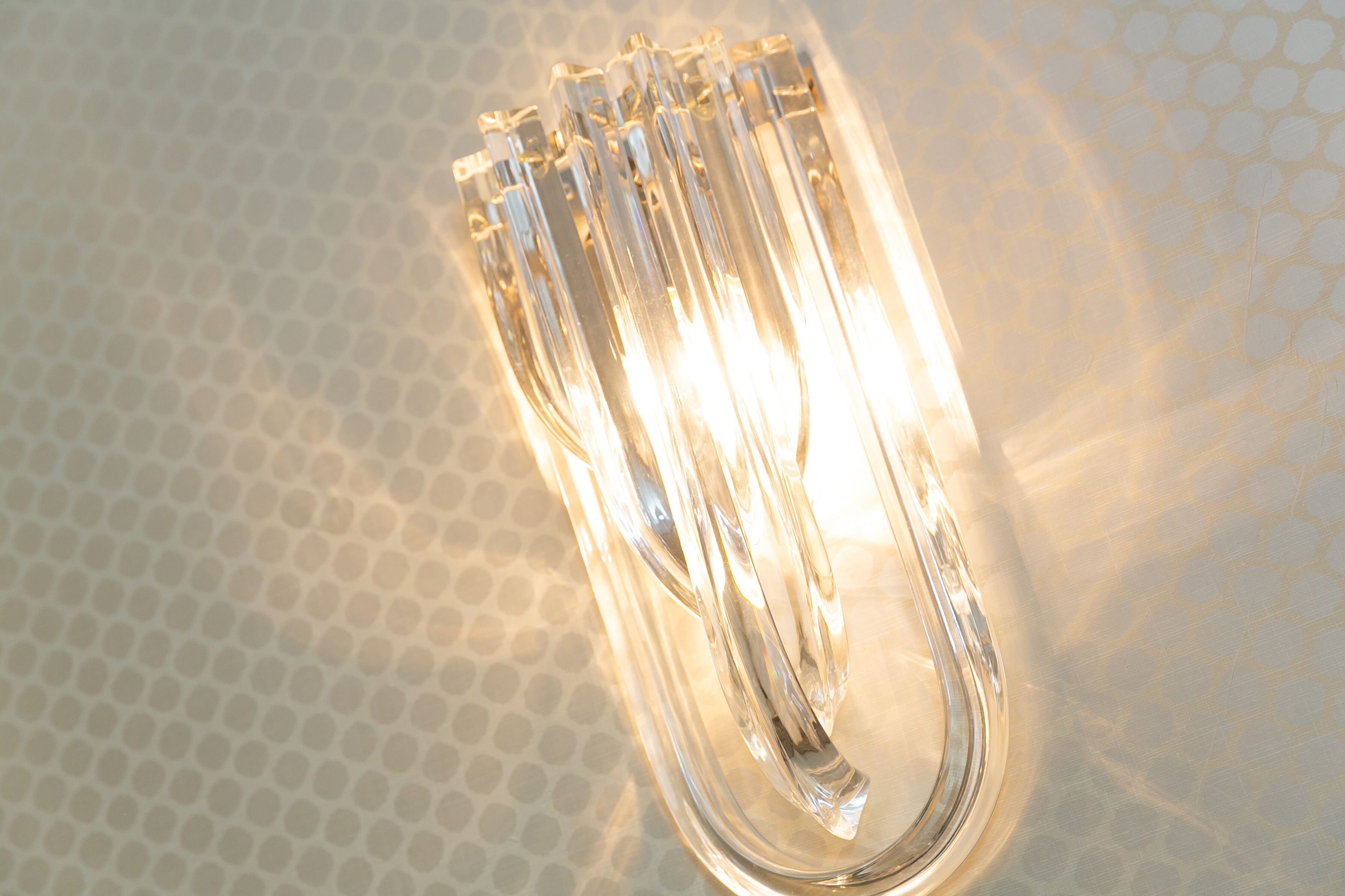 A clear glass light fixture with multiple bulbs.