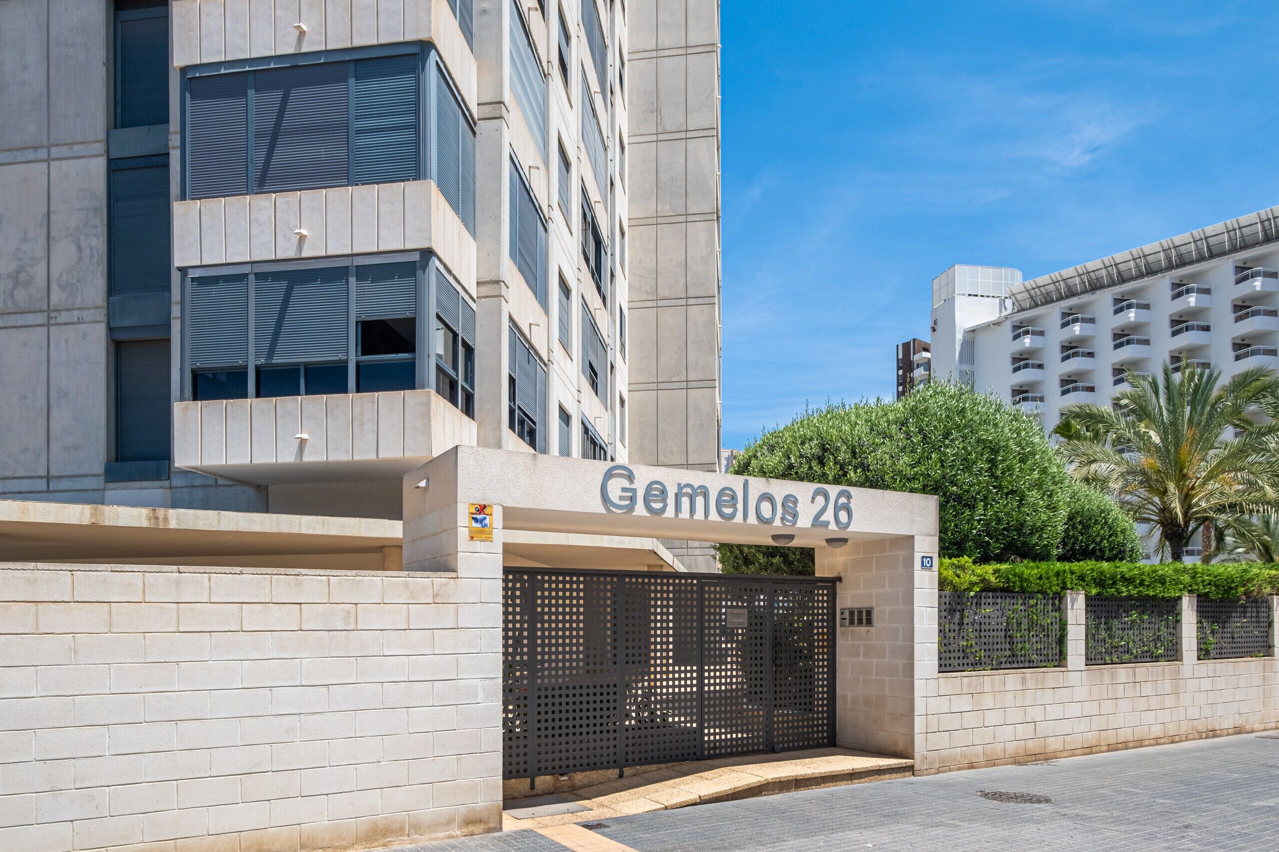 A modern building with a sign reading "Gemelos 26".