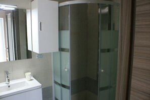A bathroom with a white sink, a mirror, and a glass-enclosed shower. - The rose of the winds vacation home IT024097C2LMWLOL4M (Sarcedo)