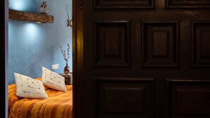 A bedroom with a bed, pillows, a vase with flowers, and a nightstand. - Casilla Daleá, Andalusia center, Natural Park, by Planetrural (Carcabuey)