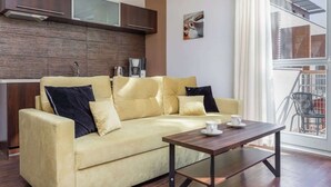 Una sala de estar moderna con sofá, una mesa de centro y vistas al exterior.