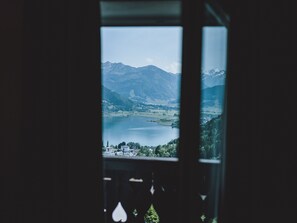 Enjoy breathtaking views of a serene lake surrounded by mountains and lush greenery.