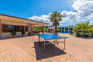 A pool table in a courtyard with a building in the background. - Finca Son Manyo 223 with pool in Mallorca (Sa Pobla)