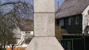 A stone-built outdoor pizza oven with a chimney, surrounded by grass and a white fence. - Haus Buchholz Apartment 2 multiple apartments available (Liesenich)