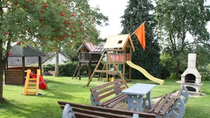 A playground with a slide, climbing structures, and a picnic table. - Haus Buchholz Apartment 2 multiple apartments available (Liesenich)