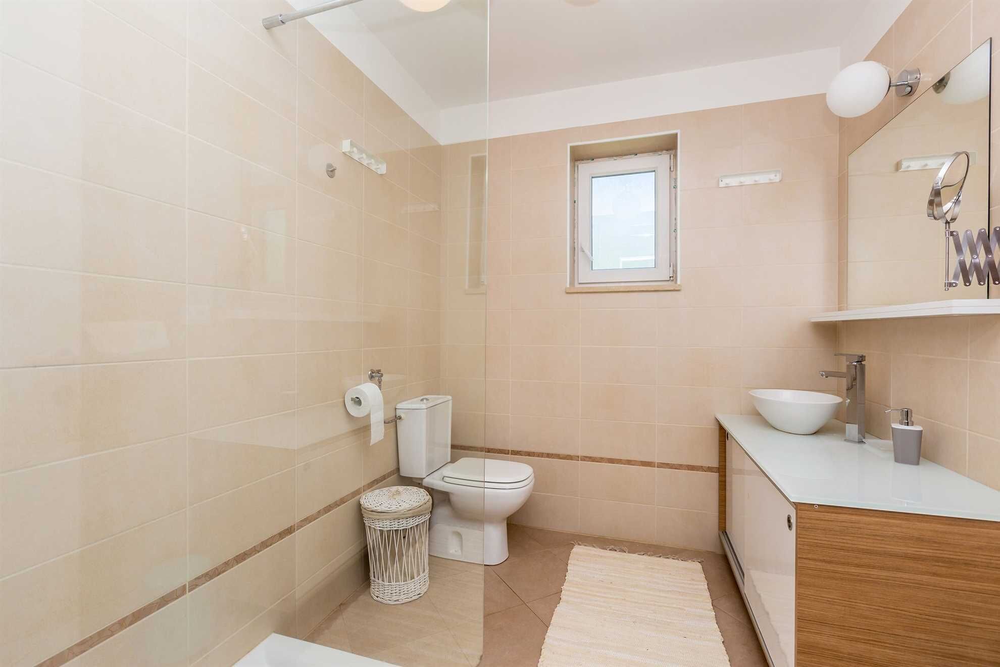 A bathroom with a toilet, bidet, and sink.