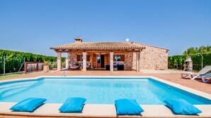 A house with a swimming pool, a covered patio, and a stone exterior. - Rural finca with pool Can Grau Petit in Mallorca (Sencelles)