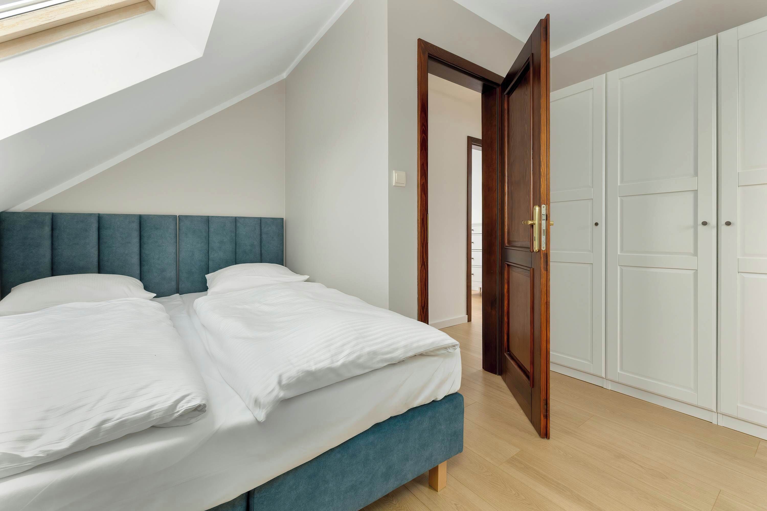 The bedroom with a spacious wardrobe makes longer stays easier, offering practical storage space.