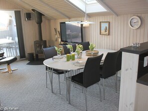 Enjoy dining in style with a round table for four, surrounded by comfortable seating and a warm ambiance.