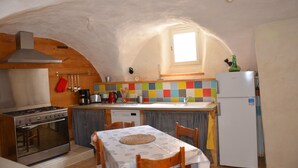 Una cocina compacta con estufa, horno y refrigerador.