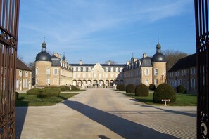 A large, historic building with multiple domed towers and a central courtyard. - Gîtes of 75m², sleeps 6 with swimming pool (JURA) (Commenailles)